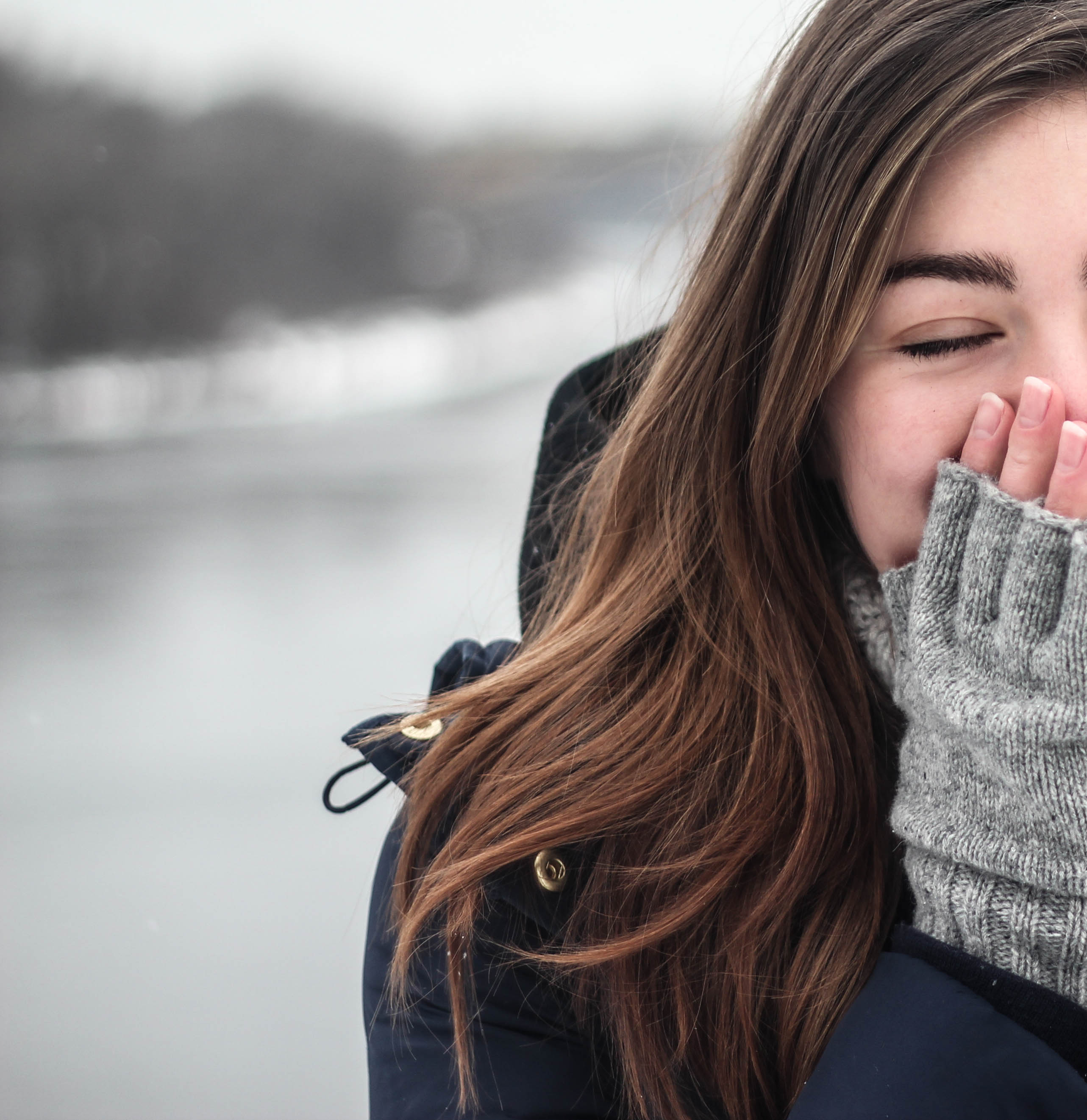 Girl covering face in the snow